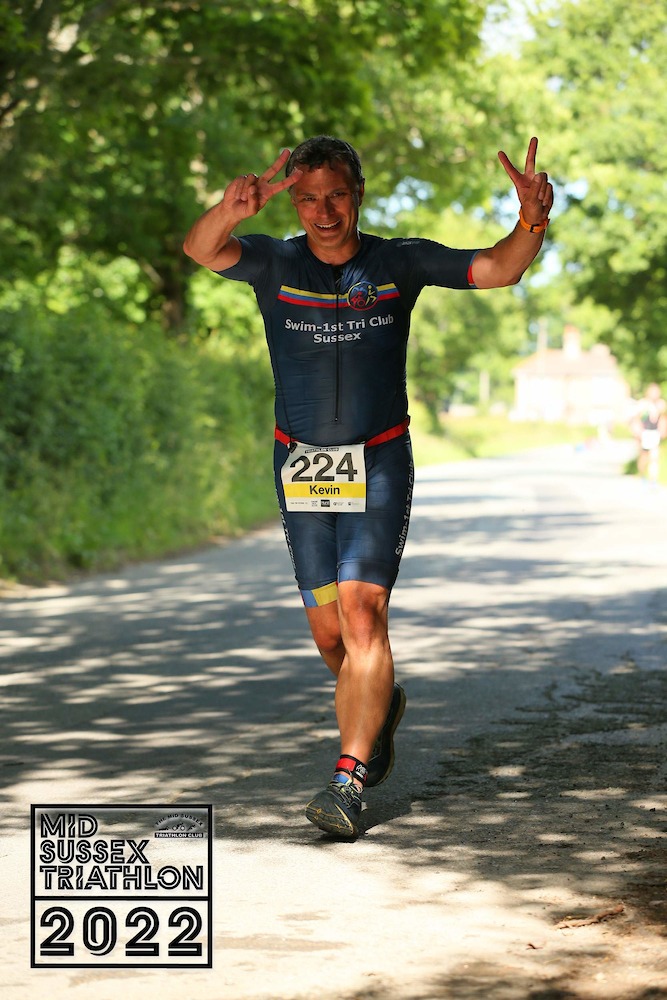 Coach Kevin raising his hands in celebration on the run